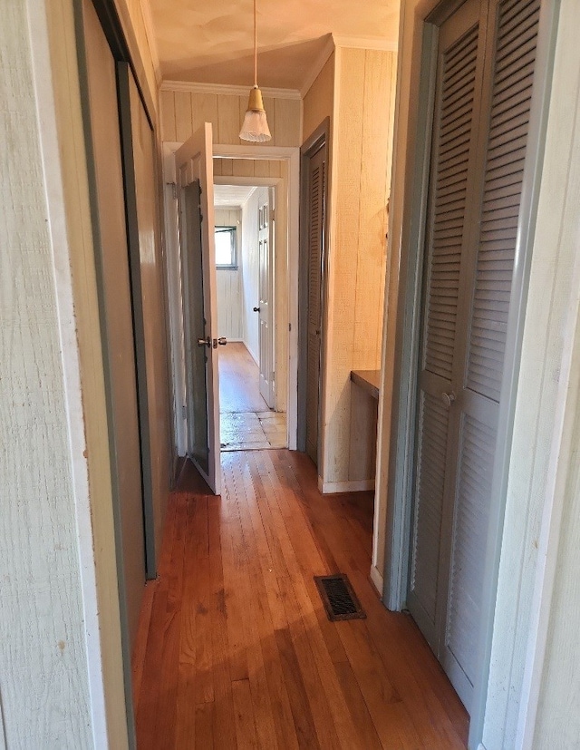 hall featuring hardwood / wood-style flooring and ornamental molding