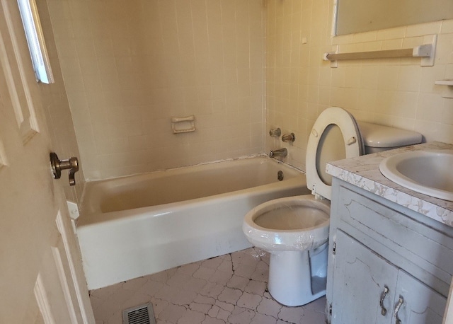 full bathroom with tile patterned floors, vanity, toilet, and tile walls