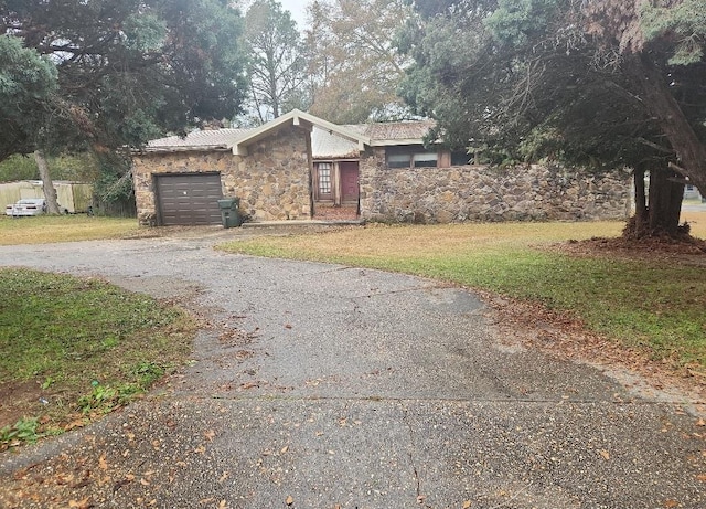 view of front of home with a front yard and a garage