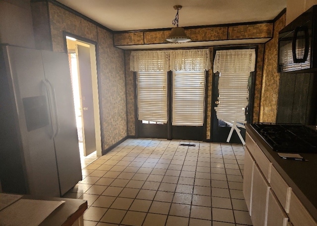 unfurnished dining area with light tile patterned flooring and ornamental molding