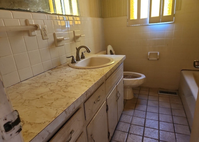 bathroom featuring vanity, toilet, and tile walls