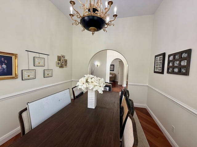 403 Stonegate Dr, Dothan, AL 36305 - dining space with a chandelier, arched walkways, wood finished floors, and a towering ceiling
