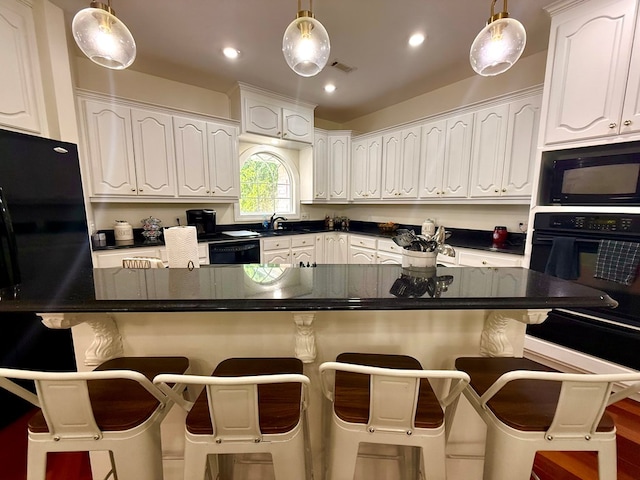403 Stonegate Dr, Dothan, AL 36305 - kitchen featuring black appliances, white cabinets, hanging light fixtures, and recessed lighting