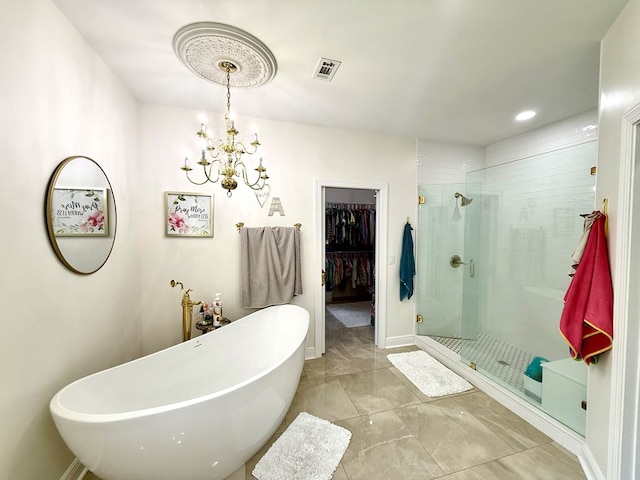403 Stonegate Dr, Dothan, AL 36305 - bathroom featuring a stall shower, a soaking tub, a chandelier, a walk in closet, and marble look tiles