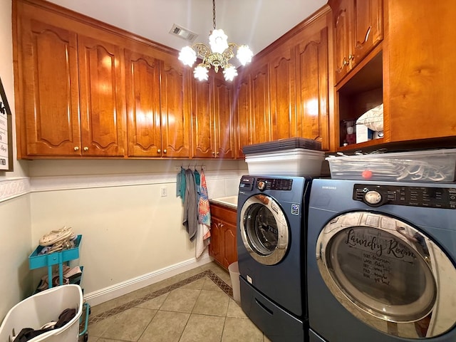 403 Stonegate Dr, Dothan, AL 36305 - laundry area with separate washer and dryer, light tile patterned floors, a chandelier, and cabinet space
