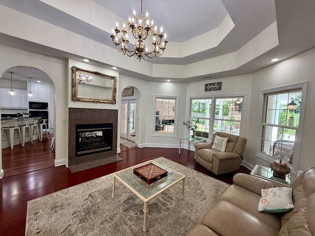 403 Stonegate Dr, Dothan, AL 36305 - living area with arched walkways, a chandelier, a multi sided fireplace, dark wood finished floors, and healthy amount of natural light
