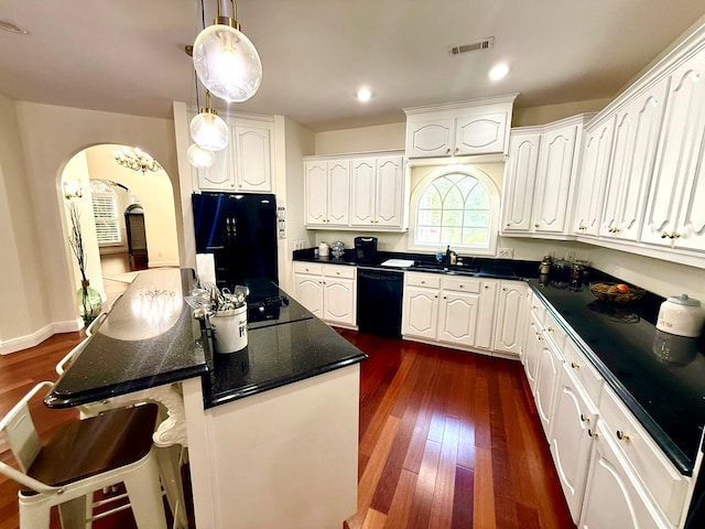 403 Stonegate Dr, Dothan, AL 36305 - kitchen featuring black appliances, arched walkways, white cabinets, dark wood finished floors, and recessed lighting