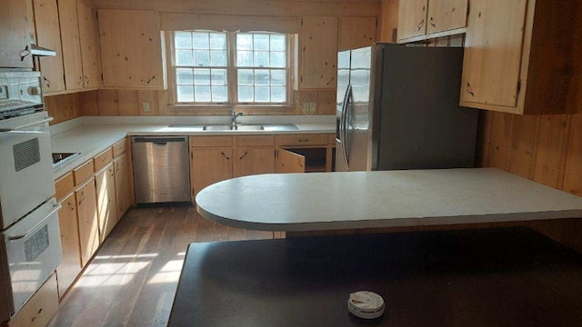 kitchen with wooden walls, light brown cabinetry, light wood-type flooring, light countertops, and stainless steel appliances