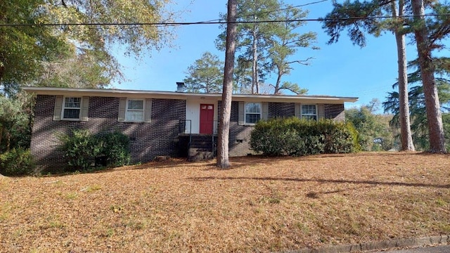 single story home featuring a front lawn, brick siding, and crawl space