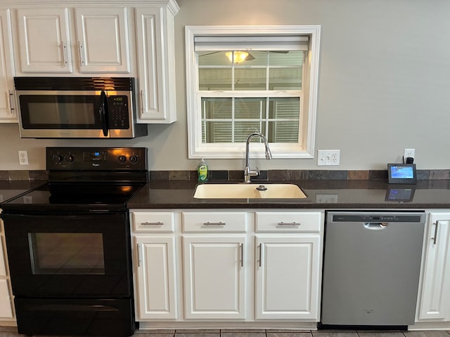 kitchen featuring white cabinetry, stainless steel appliances, and a sink