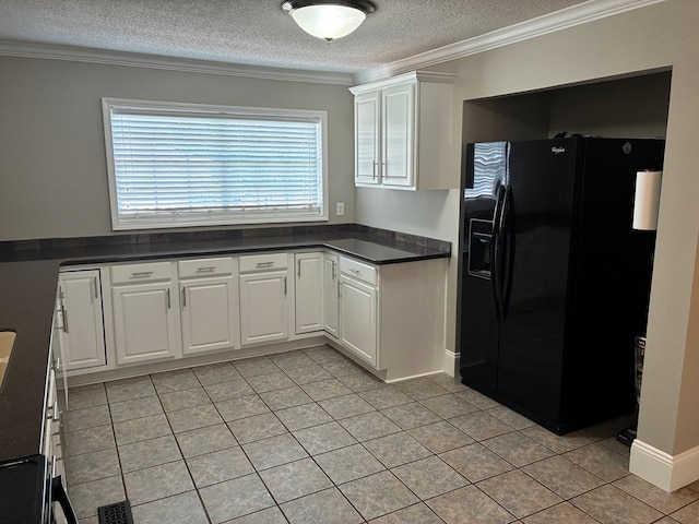 kitchen with light tile patterned floors, dark countertops, black fridge, a textured ceiling, and crown molding