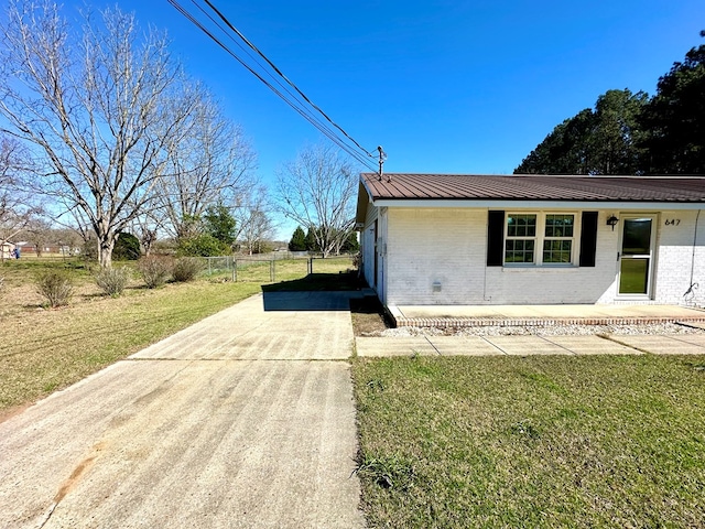 view of property exterior featuring a lawn