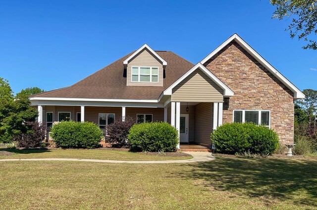 1621 Adkinson Rd, Newton, AL 36352 - view of front of home with a front yard, stone siding, and covered porch
