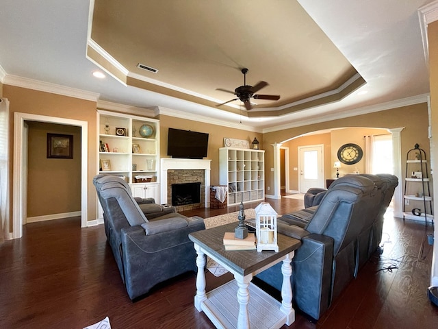 1621 Adkinson Rd, Newton, AL 36352 - living area featuring a tray ceiling, ceiling fan, arched walkways, crown molding, and ornate columns