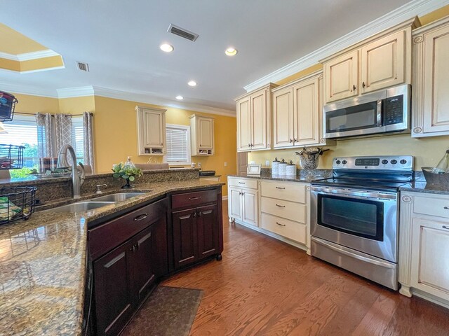 1621 Adkinson Rd, Newton, AL 36352 - kitchen with stainless steel appliances, cream cabinetry, a sink, crown molding, and dark wood-style floors