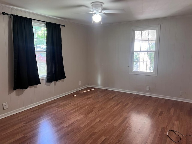 empty room featuring ceiling fan, ornamental molding, and hardwood / wood-style flooring