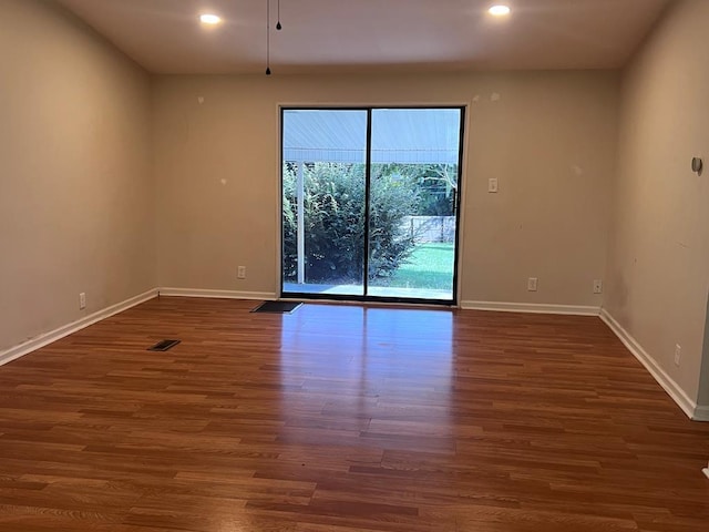 unfurnished room featuring dark hardwood / wood-style flooring