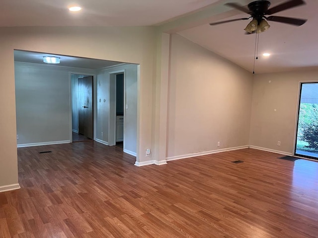 empty room with ceiling fan, wood-type flooring, and vaulted ceiling