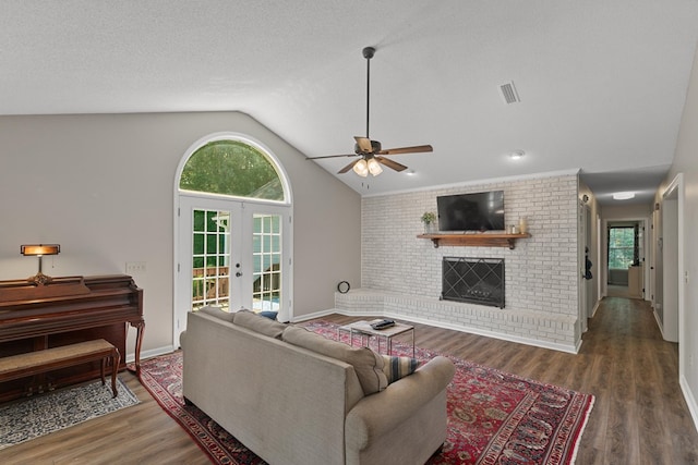 102 Lindsey Ln, Dothan, AL 36305 - living area featuring french doors, lofted ceiling, a ceiling fan, wood finished floors, and a brick fireplace