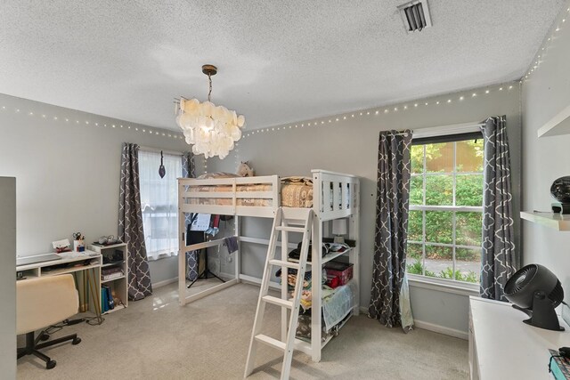 102 Lindsey Ln, Dothan, AL 36305 - carpeted bedroom with a chandelier, a textured ceiling, and baseboards