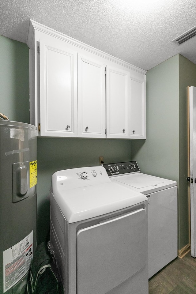 102 Lindsey Ln, Dothan, AL 36305 - laundry room featuring independent washer and dryer, cabinet space, electric water heater, a textured ceiling, and dark wood-style flooring