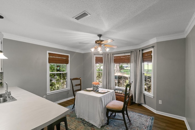 102 Lindsey Ln, Dothan, AL 36305 - dining area with dark wood-type flooring, baseboards, a textured ceiling, a ceiling fan, and ornamental molding