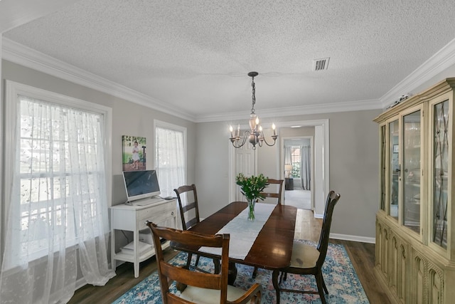 102 Lindsey Ln, Dothan, AL 36305 - dining room with a chandelier, dark wood-style floors, a textured ceiling, crown molding, and baseboards