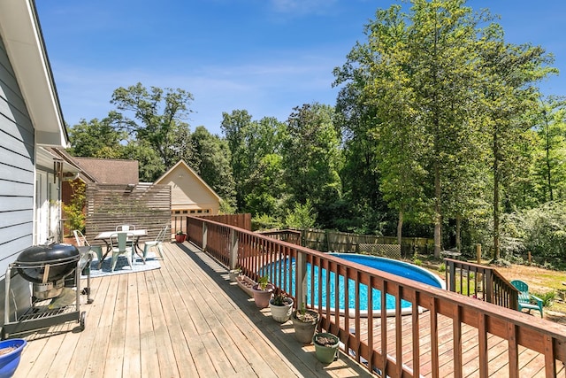 102 Lindsey Ln, Dothan, AL 36305 - deck featuring a fenced backyard, outdoor dining area, a grill, and view of scattered trees