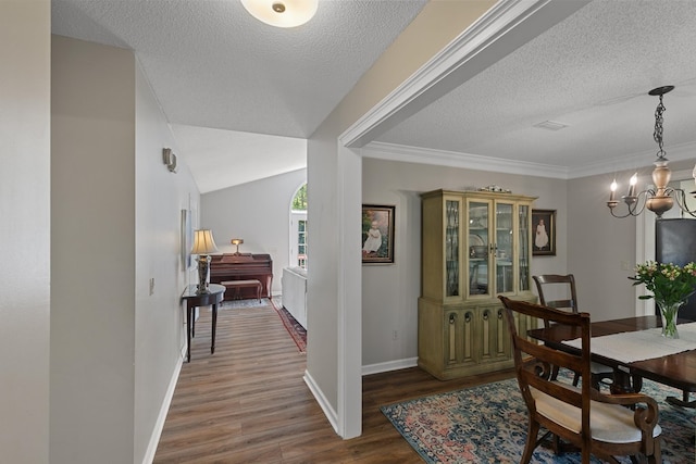 102 Lindsey Ln, Dothan, AL 36305 - dining space with a chandelier, wood finished floors, a textured ceiling, and baseboards