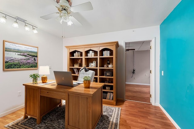 office with ceiling fan, light hardwood / wood-style floors, and track lighting