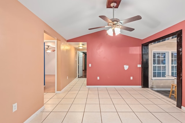 unfurnished room with ceiling fan, lofted ceiling, and light tile patterned flooring