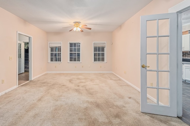 unfurnished room with ceiling fan and light colored carpet