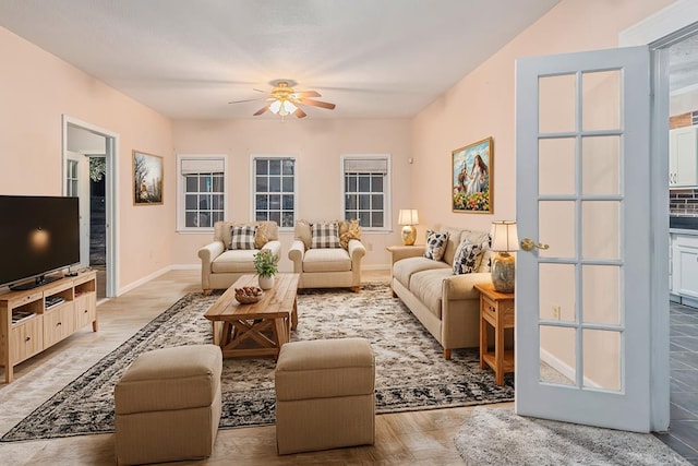 living room with ceiling fan and light hardwood / wood-style flooring