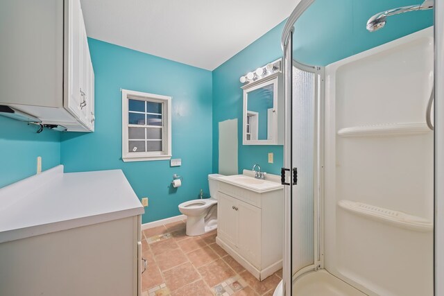 bathroom featuring vanity, toilet, and a shower with door