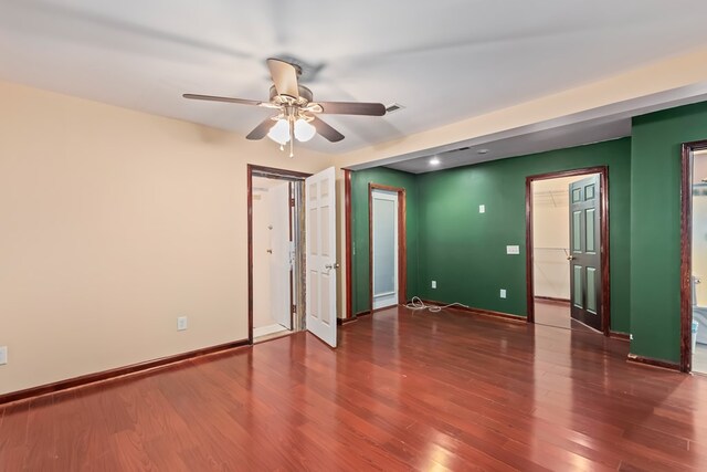 spare room featuring ceiling fan and dark wood-type flooring