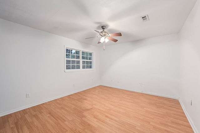 spare room with light wood-type flooring and ceiling fan