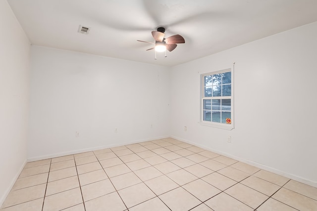 unfurnished room with ceiling fan and light tile patterned flooring