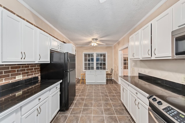 kitchen with decorative backsplash, ceiling fan, white cabinets, and appliances with stainless steel finishes