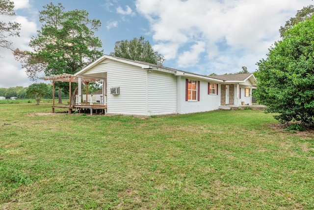 view of side of property with a lawn and a pergola