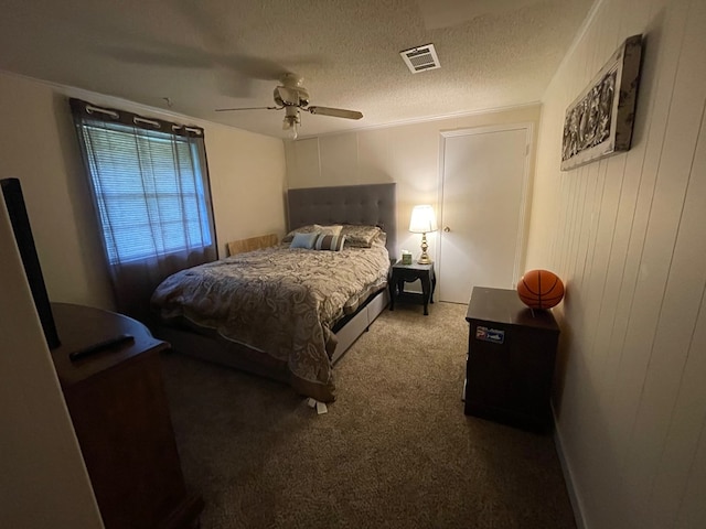 bedroom featuring a textured ceiling, carpet floors, and ceiling fan