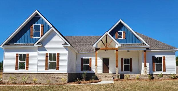 861 Clayton Rd, Ashford, AL 36312 - view of front of house featuring board and batten siding, covered porch, and a front yard