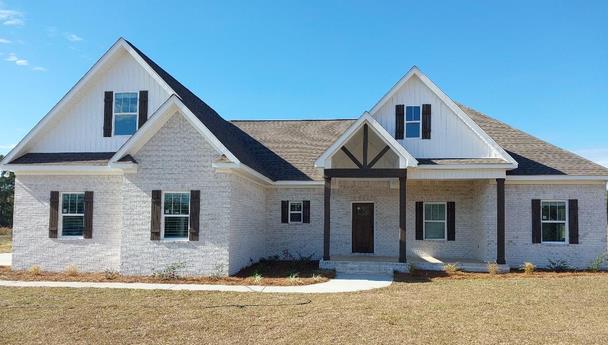 861 Clayton Rd, Ashford, AL 36312 - view of front of property featuring covered porch, board and batten siding, a front yard, and brick siding