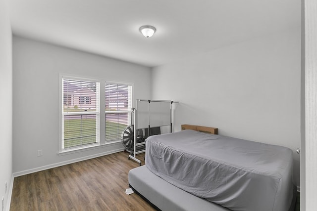 bedroom featuring baseboards and wood finished floors
