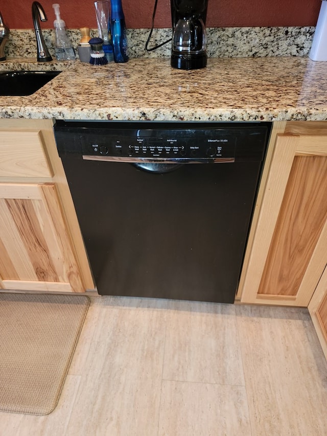 interior details with light stone countertops, dishwasher, sink, light hardwood / wood-style flooring, and light brown cabinetry