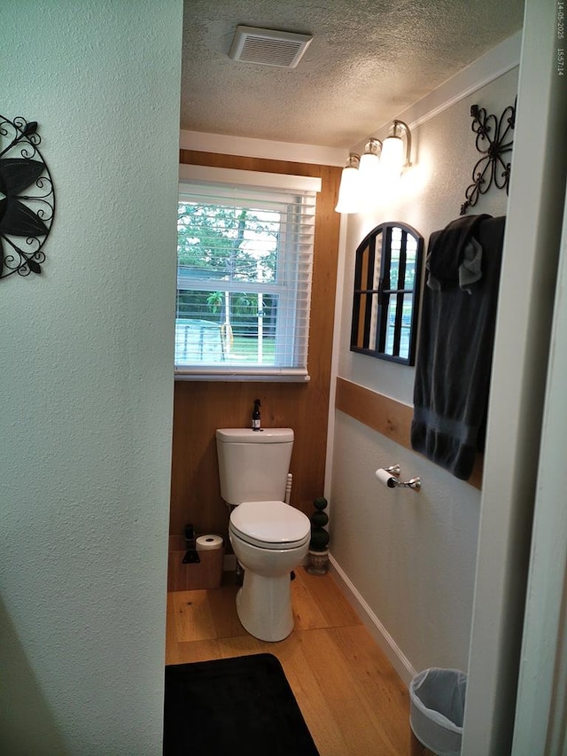 4301 County Road 156, Enterprise, AL 36330 - bathroom with a textured ceiling, toilet, wood finished floors, baseboards, and a textured wall