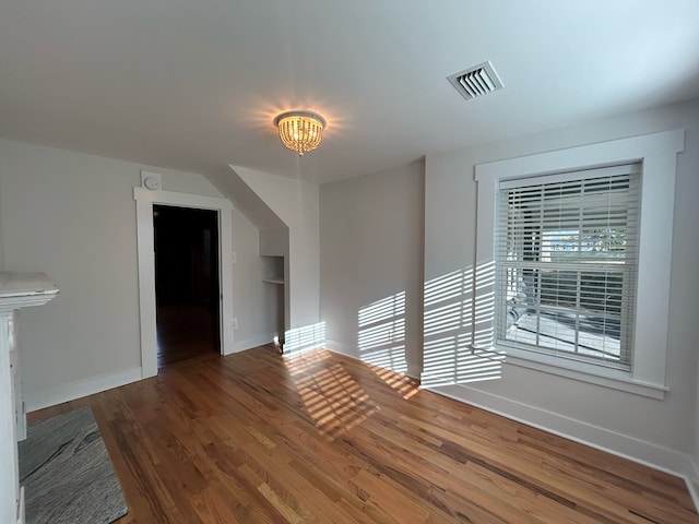 interior space with dark hardwood / wood-style flooring and an inviting chandelier