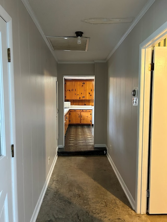 corridor with ornamental molding and wooden walls