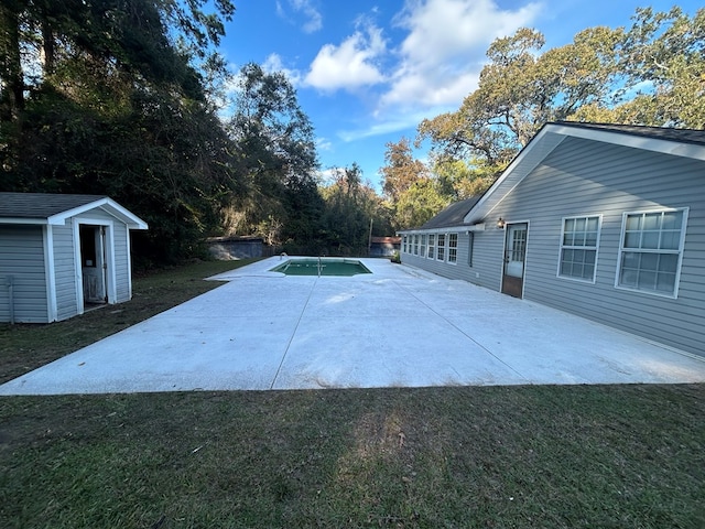 exterior space featuring a lawn, a storage shed, and a patio