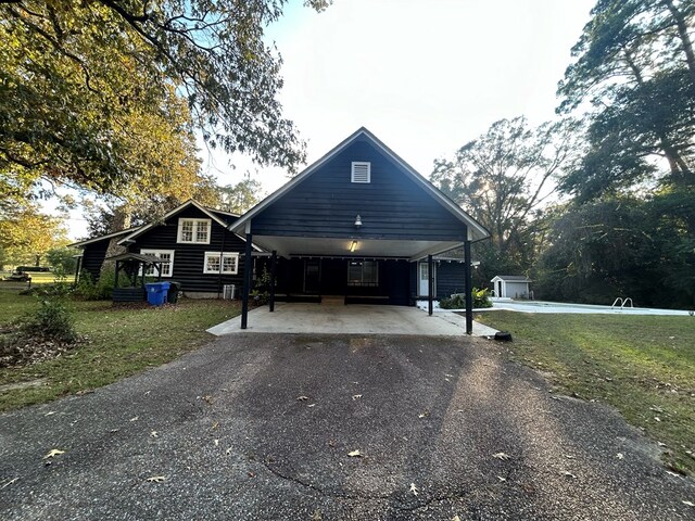 view of front of house with a front lawn and a carport