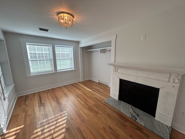 unfurnished living room with a fireplace and hardwood / wood-style floors